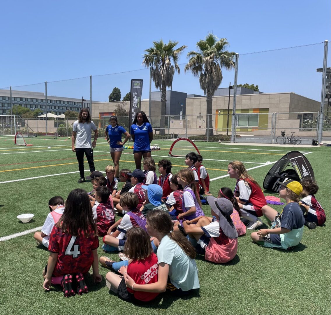 A group of children sitting on the ground.